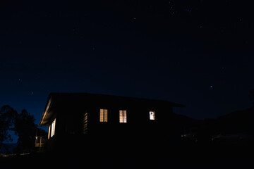 house at night with the backdrop of stars