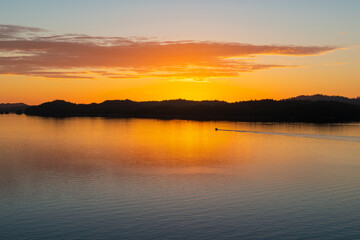 Prince Rupert sunset with fishing boat, the harbor famous for the British Columbia Inside Passage cruise between Prince Rupert and Port Hardy, Canada.