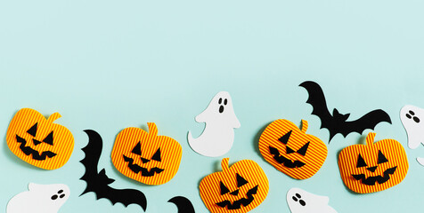 Halloween party concept with fun paper decor, pumpkins, ghost