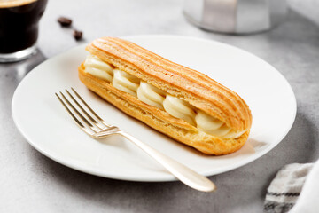 Traditional french eclairs filled with vanilla cream and powdered sugar.