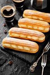 Traditional french eclairs filled with vanilla cream and powdered sugar.