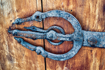Vintage door metal hinge in the old wooden gate in Morocco.