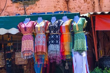 Sales of the national clothes at the market in the medina of Marrakesh on a sunny day. Morocco.