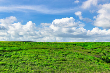 Fototapeta na wymiar Photo of hills with clouds and blue sky, hills and blue sky with copy space