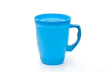 Blue color plastic glass or jug close up on isolated white background with reflection