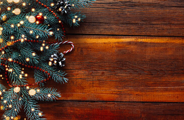 wooden Christmas background made of scattered lights with a decorated Christmas tree. space for text