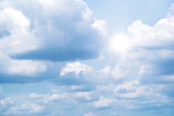 Fototapeta premium clouds floating around the houses, both small and large, the sun is shining brightly.