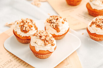 Muffin. Creme muffins with caramel and nuts. Creme on the top of muffin. Caramel muffins.  