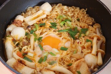 Boiled instant noodles with mushrooms and eggs