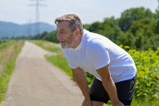 Middle-aged Man Pausing For A Break To Catch His Breath