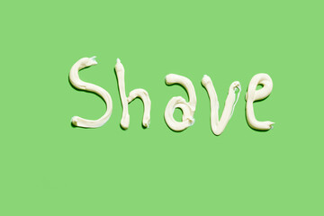 Shave word written with shaving cream on the green background