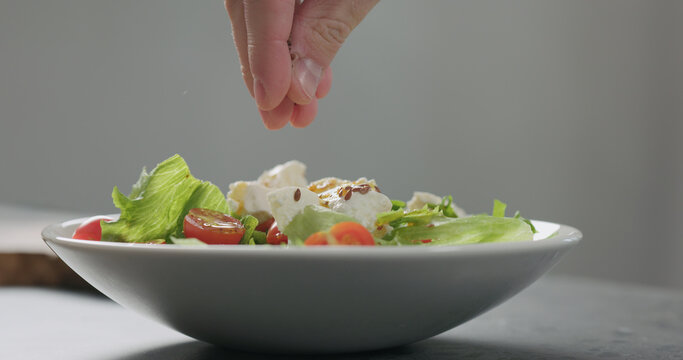 Add Flaxseed To Salad With Cherry Tomatoes And Ricotta In White Bowl