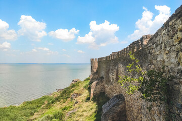 Naklejka premium Medieval walls of a defensive castle overlooking the sea strait.