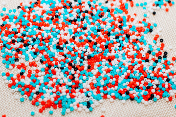 Multicolored blue, white, red beads close up.
