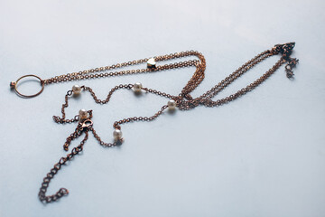cheap jewelry chain bracelet and ring blackened from water on white background.
