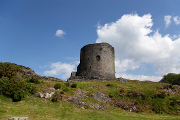 Fototapeta na wymiar Dolbadarn Castle in Llanberis, Gwynedd, North Wales. Medieval castle on a hill with a blue sky