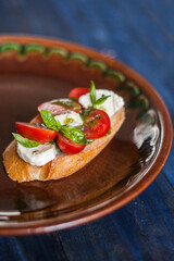 bruschetta with tomato , cheese and basil