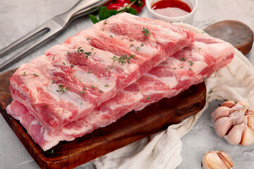 Raw ribs on ligth gray background. Gourmet cooking food concept.