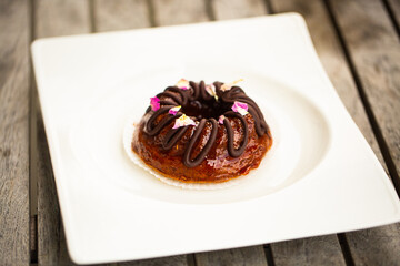 Mini bundt cake with chocolate on a white plate