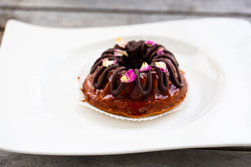 Mini bundt cake with chocolate on a white plate