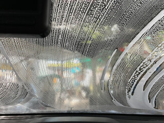 Bubble water on the windshield for cleaning.