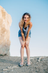 happy traveler girl is standing on the top of a mountain