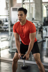 Fototapeta na wymiar Muscle stong man exercise biceps in gym