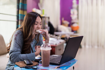 Busy woman eat sandwich and work from home