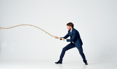 business man in suit pulling rope career office manager