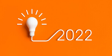 2022 Creativity and inspiration ideas with lightbulb on color background.Business solution or smart...