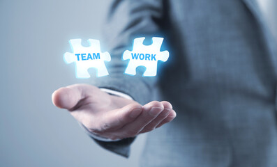 Man holding jigsaw puzzle. Teamwork