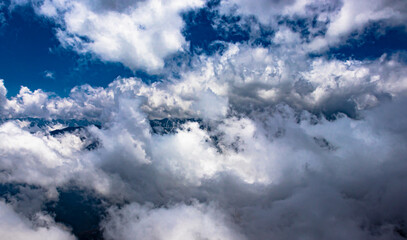 mountain with cloud patches and blue sky at morning from flat angle