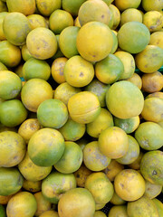 pile of yellow oranges in supermarket