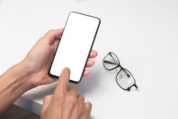 Hand touching smartphone with blank screen,