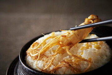 Ripe ginseng on cast iron pot rice
