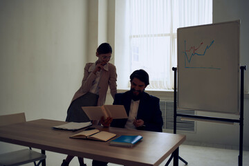 business man and woman sitting at work desk office team communication