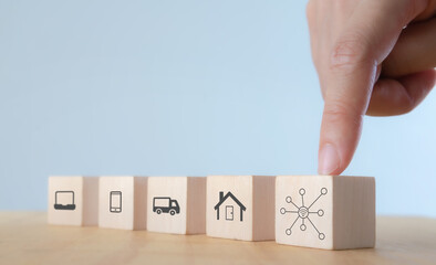 Internet of things (IOT) Everything connectivity device concept. Digital tech for better life.Wooden cubes with IOT icon; computer, mobile phone, car and smart home on white background with copy space