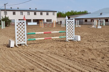 empty show jumping arena with obstacles, barriers and poles, horse riding, equestrian sport and...