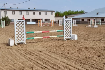Foto op Canvas empty show jumping arena with obstacles, barriers and poles, horse riding, equestrian sport and horses concept, competition field, background wallpaper  © annet