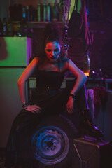 Fototapeta na wymiar girl in a futuristic cyberpunk costume with neon lighting. The concept of the future post-apocalypse