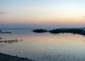 summer landscape on the shore of the lake at dawn, colors in the sky before sunrise, Lake Burtnieki, Latvia