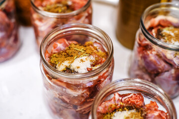 Cooking stew at home. Meat in glass jars, prepared for seaming and autoclaving. Close-up