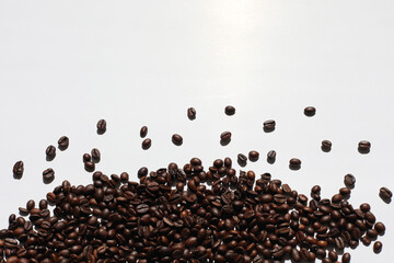 macro view of coffee beans on white paper background