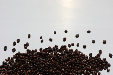 pile of coffee beans isolated on white paper background