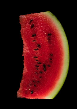 One skibble of ripe watermelon on a black background isolated