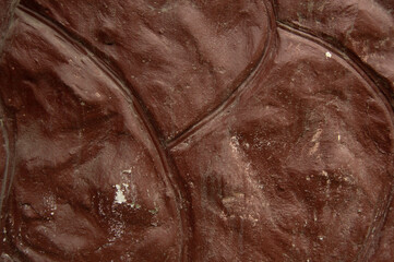 Brown concrete wall in the shape of a large stone. Background, texture