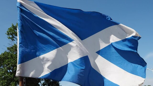 Close-up of flag of Scotland waving during hard wind. Edinburgh, Scottish flag in a street in UK. Video 4k resolution. 