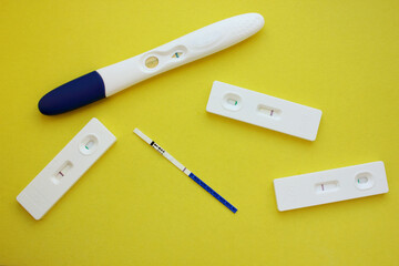 Five negative pregnancy tests on a yellow background. Motherhood, children, pregnancy, the concept of birth control. Health problems and problems with conception. abortion. Copy space.