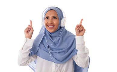 Music and technology concept-young happy asian muslim woman enjoing using headphone to listen the music and pointing fingers up, isolated on white background