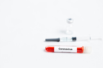 Corona virus blood sample ,syring and vaccine vial on white background.